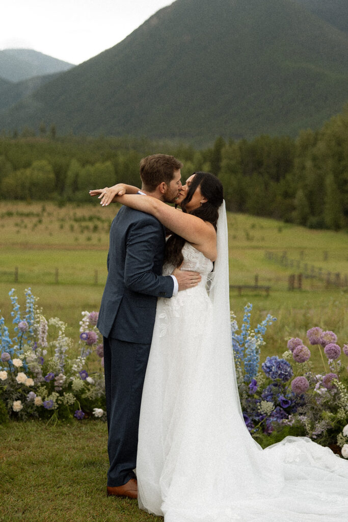 Bride and groom sharing a candid moment during their Montana wedding day
