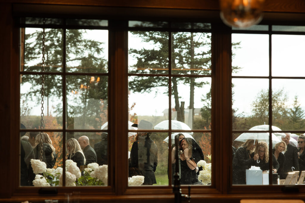 Intimate wedding reception at a rustic Montana lodge under string lights.
