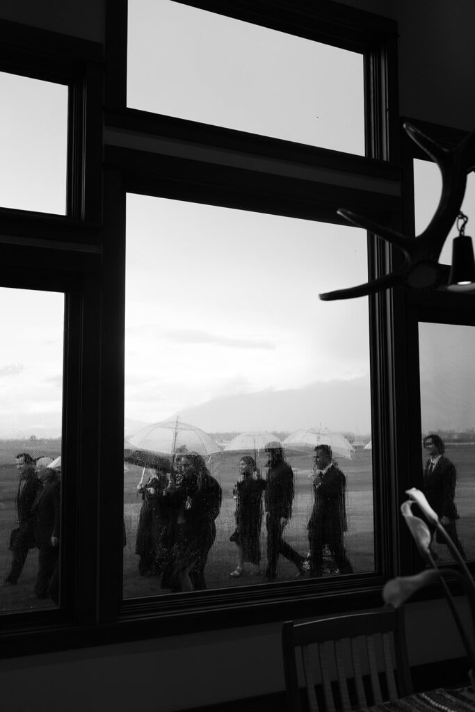 Wedding ceremony overlooking open fields and distant peaks in Montana.
