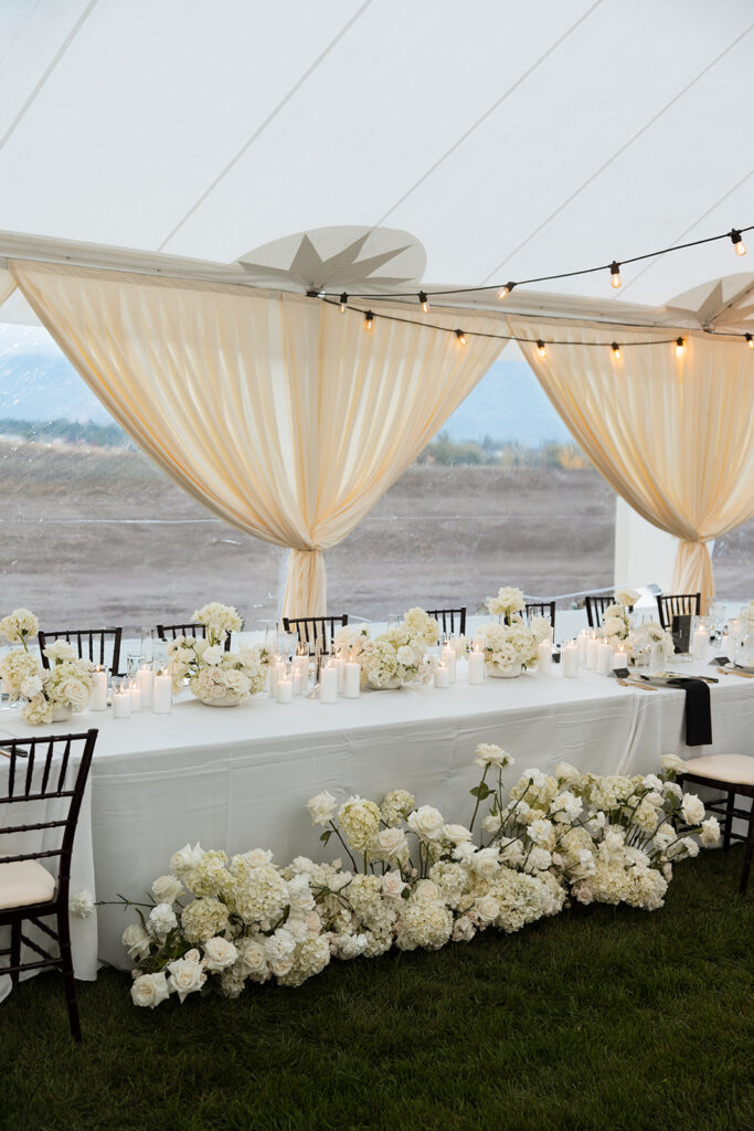 Intimate wedding reception at a rustic Montana lodge under string lights.
