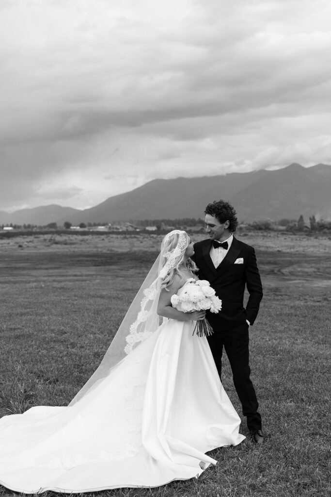 Bride and groom sharing a quiet moment surrounded by Montana mountain views.
