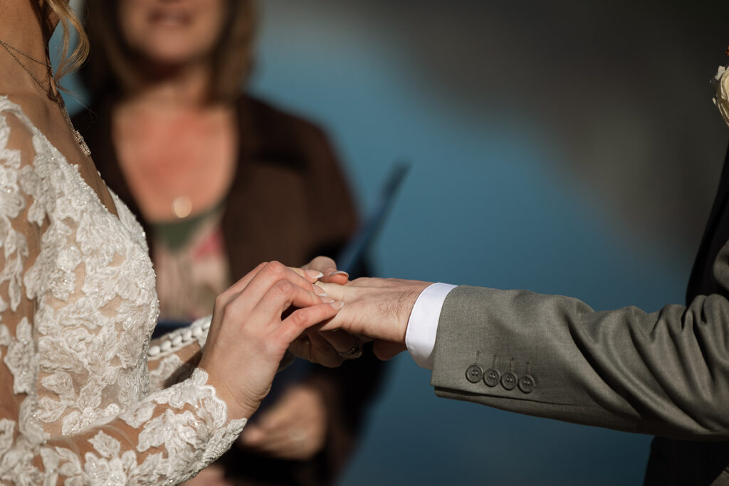 Bride and groom sharing a quiet moment beside the turquoise water at Bowman Lake
