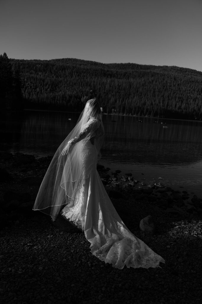 Newlyweds walking along the forest path near Bowman Lake after their ceremony
