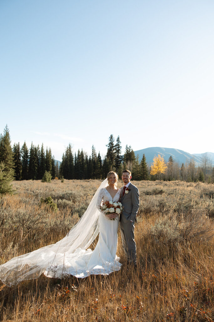 Newlyweds walking along the forest path near Bowman Lake after their ceremony
