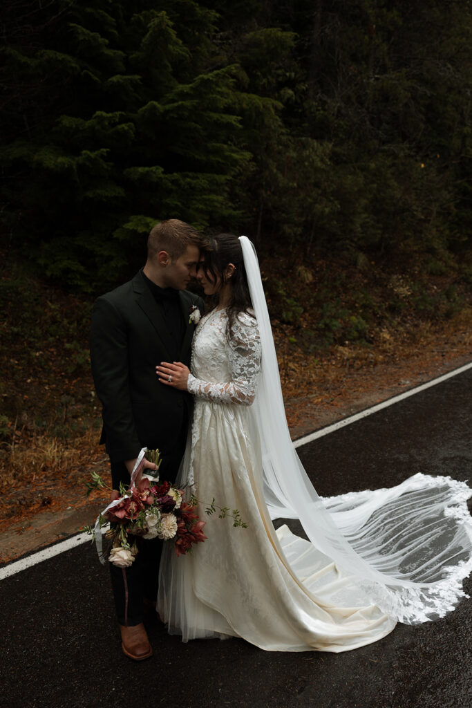 Couple eloping in Glacier National Park with mountain views in the background