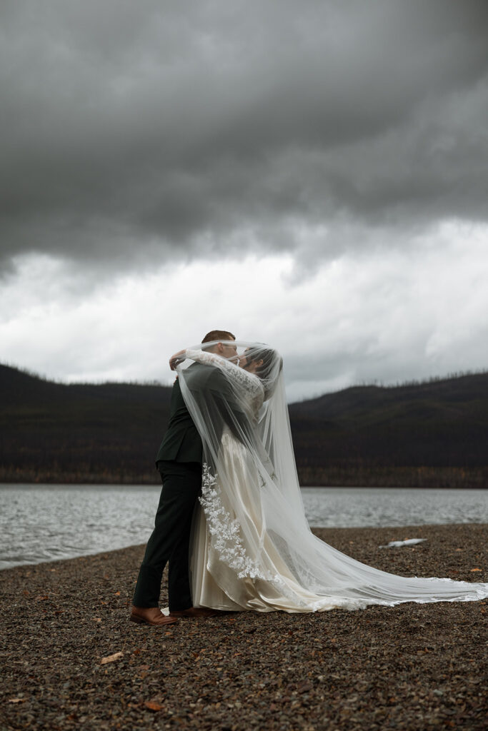 Couple eloping in Glacier National Park with mountain views in the background

