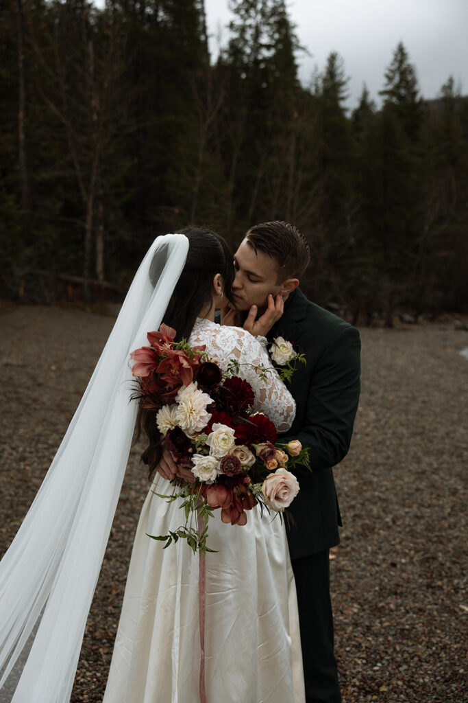 Adventurous couple celebrating their elopement in Glacier National Park surrounded by nature
