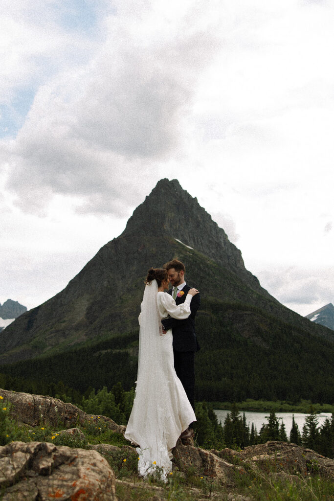 Glacier National Park sunrise elopement with a couple exchanging private vows as the mountains slowly light up at dawn.