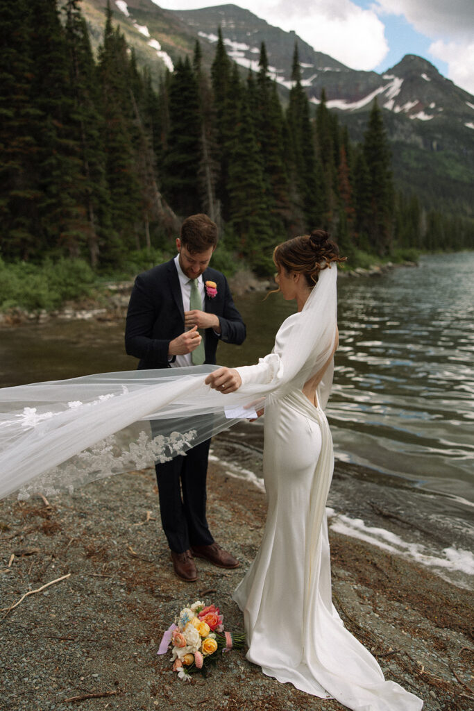 Glacier National Park sunrise elopement with a couple exchanging private vows as the mountains slowly light up at dawn.
