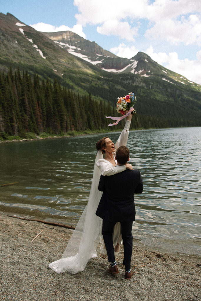 Glacier National Park sunrise elopement with a couple exchanging private vows as the mountains slowly light up at dawn.