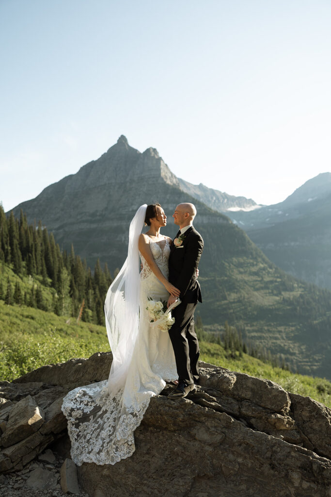 Couple eloping in Glacier National Park with mountain views, captured by a Montana photographer during a calm, intimate ceremony.