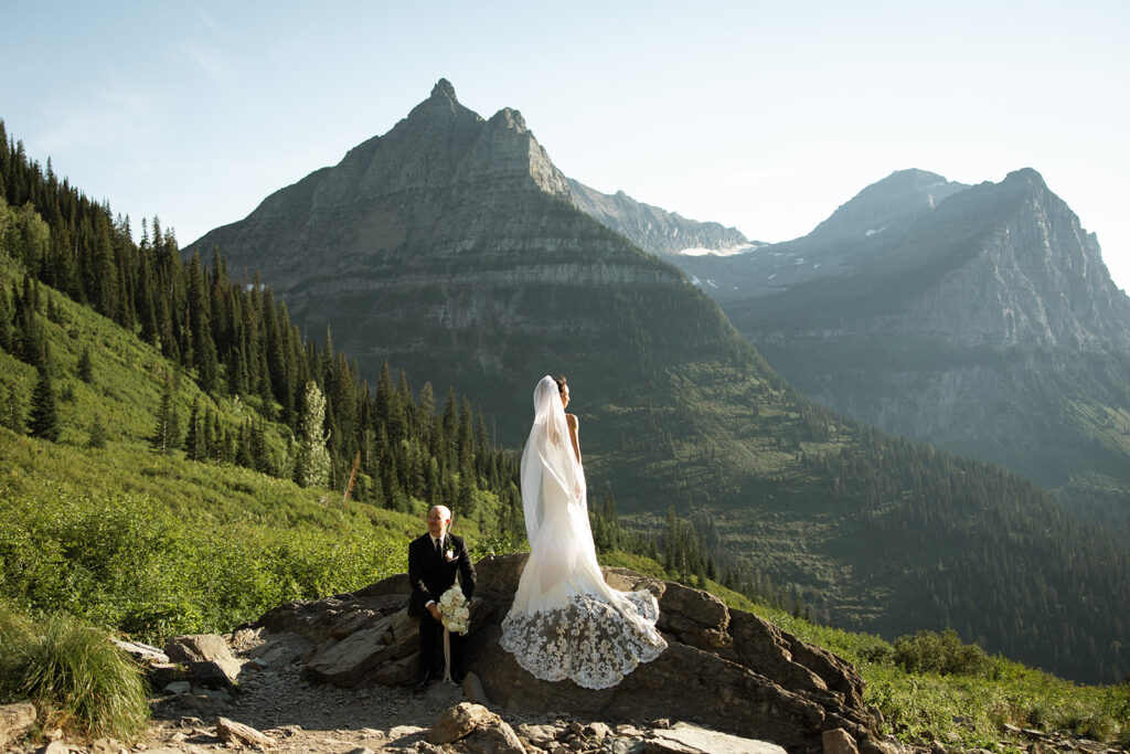 Couple eloping in Glacier National Park with mountain views, captured by a Montana photographer during a calm, intimate ceremony.
