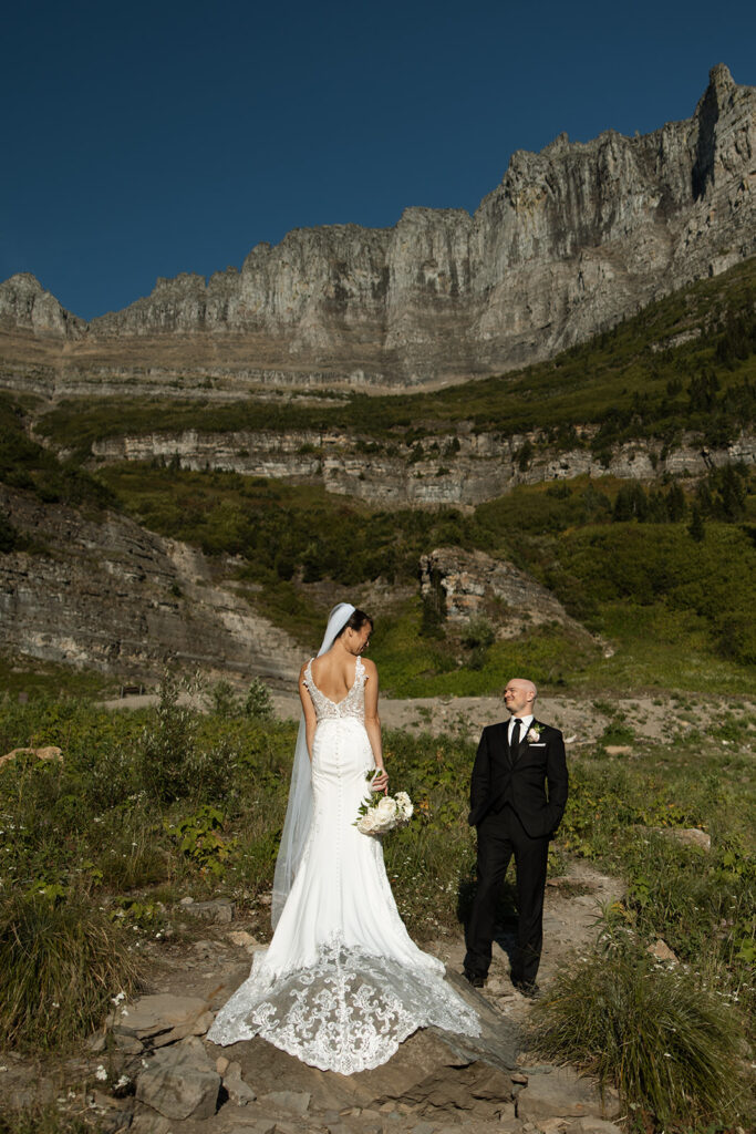 Elopement couple laughing together in Glacier National Park after their vows
