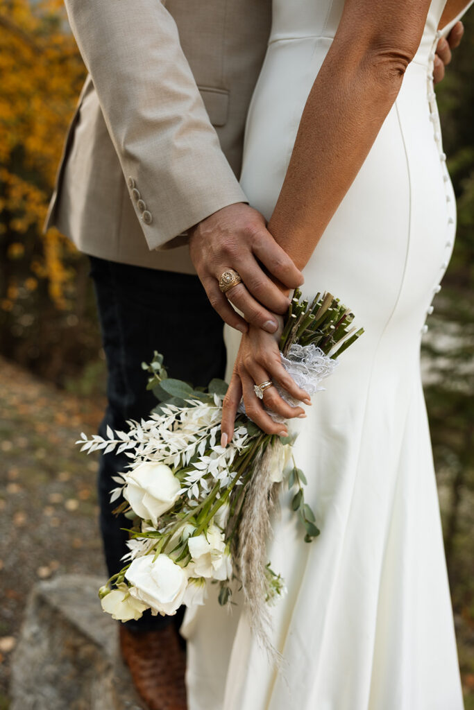Intimate Glacier National Park elopement ceremony beside an alpine lake surrounded by peaks