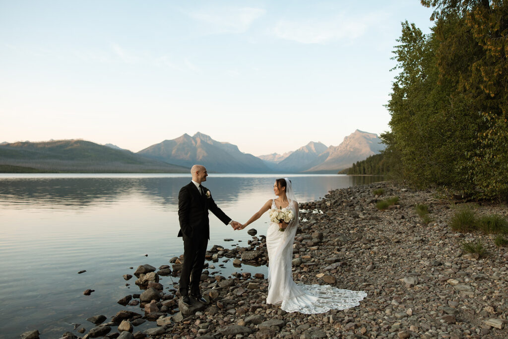 Elopement couple laughing together in Glacier National Park after their vows
