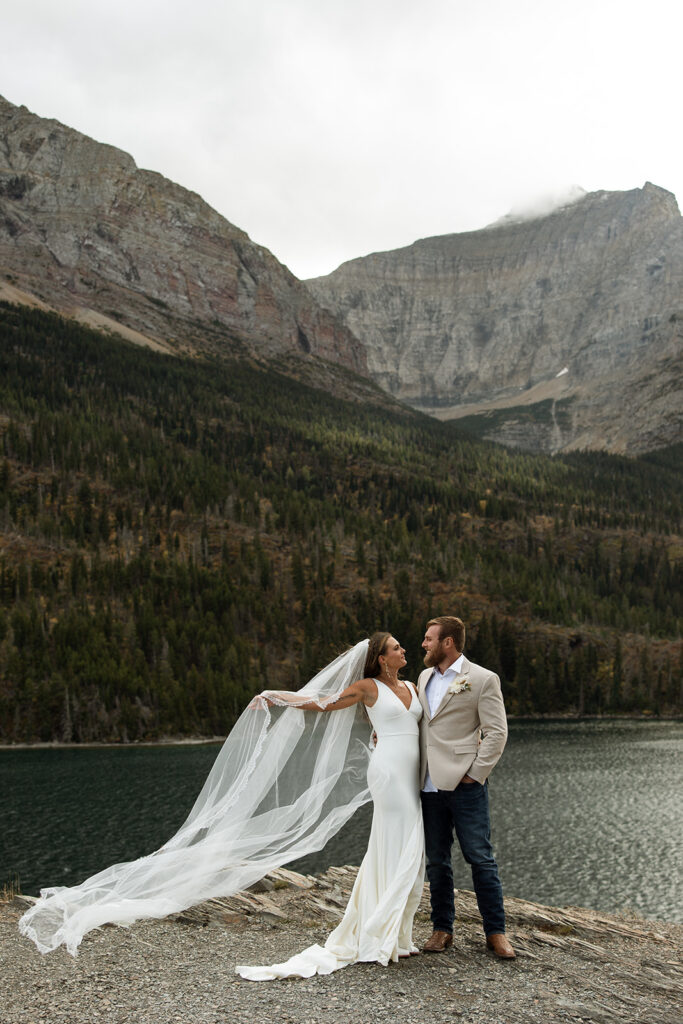 Intimate Glacier National Park elopement ceremony beside an alpine lake surrounded by peaks