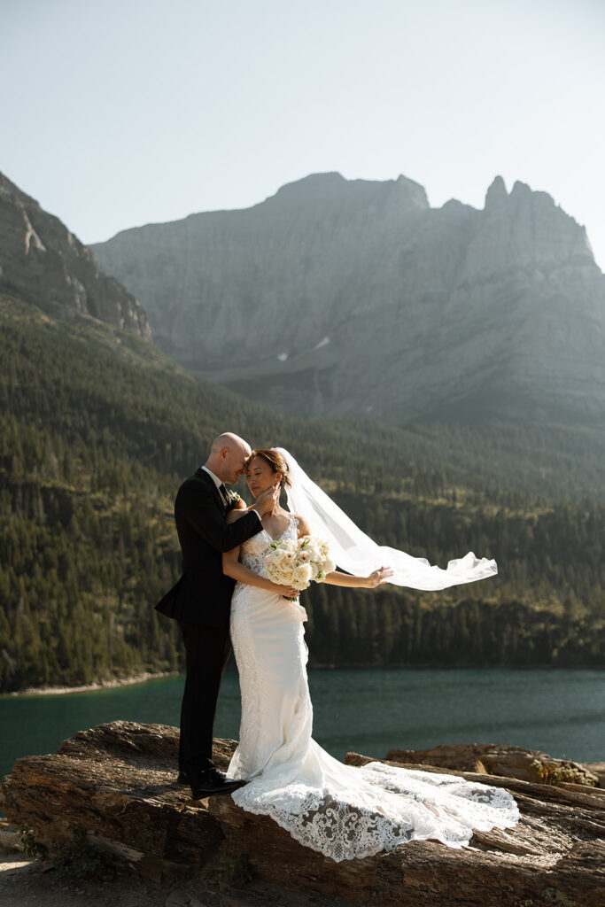 Elopement couple laughing together in Glacier National Park after their vows
