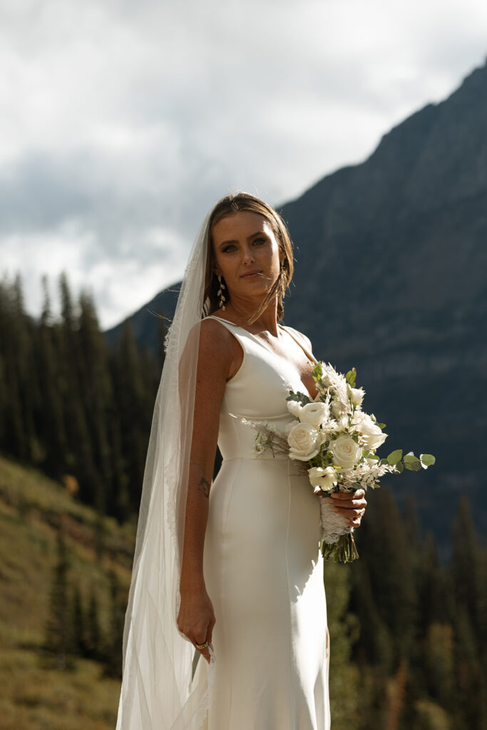 Intimate Glacier National Park elopement ceremony beside an alpine lake surrounded by peaks