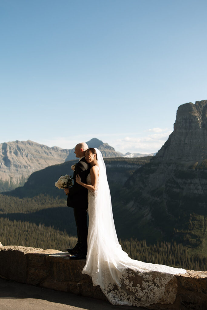 Couple eloping in Glacier National Park with mountain views, captured by a Montana photographer during a calm, intimate ceremony.