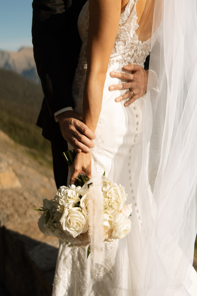 Couple eloping in Glacier National Park with mountain views, captured by a Montana photographer during a calm, intimate ceremony.
