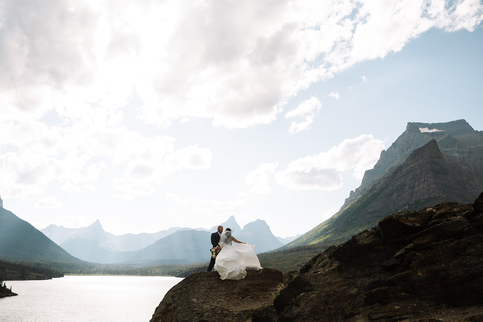 Couple celebrating outdoors in a scenic mountain landscape during an intimate elopement.
