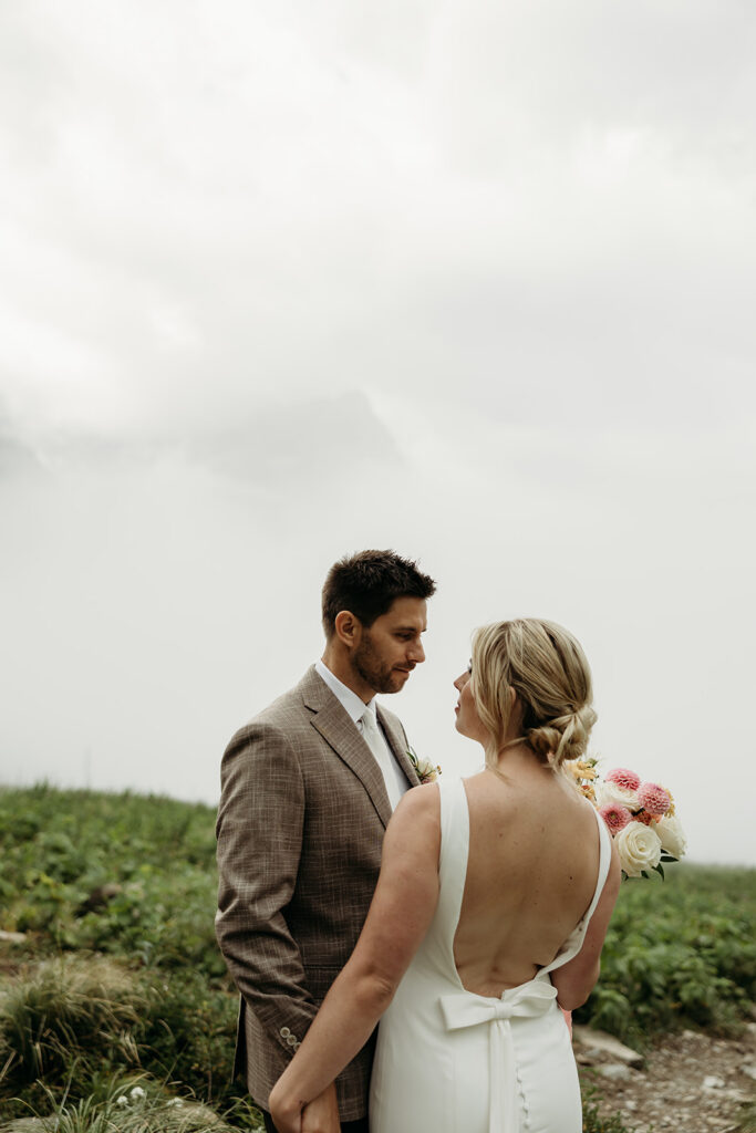 Couple standing together in Glacier National Park during their intimate mountain elopement.