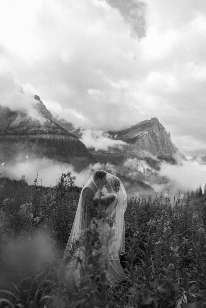 Romantic elopement portraits with mountains and water in the background.