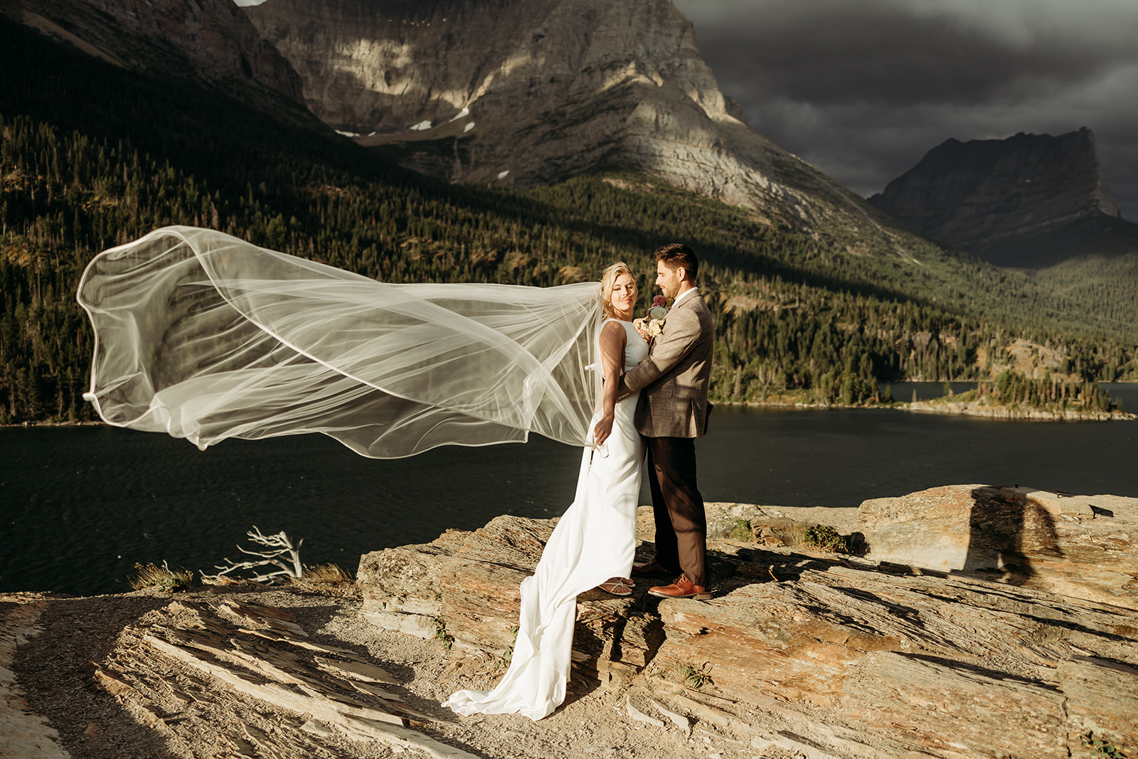 Couple standing together in Glacier National Park during their intimate mountain elopement.