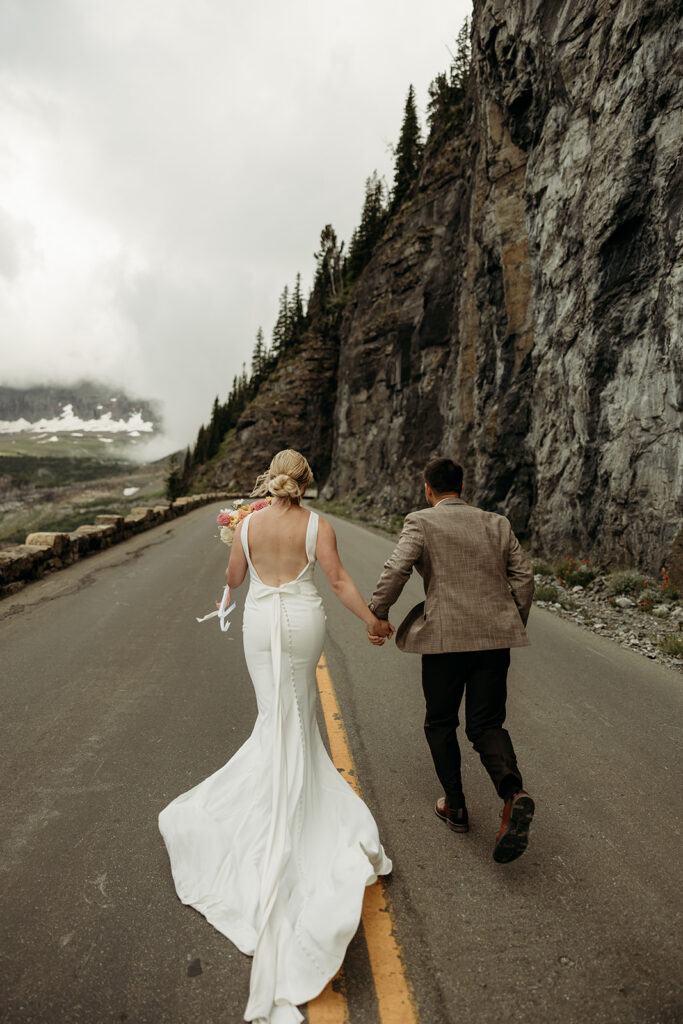 Couple standing together in Glacier National Park during their intimate mountain elopement.