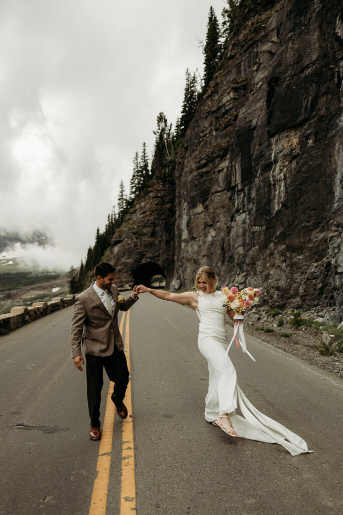 Adventure elopement moment in Glacier National Park at sunrise
