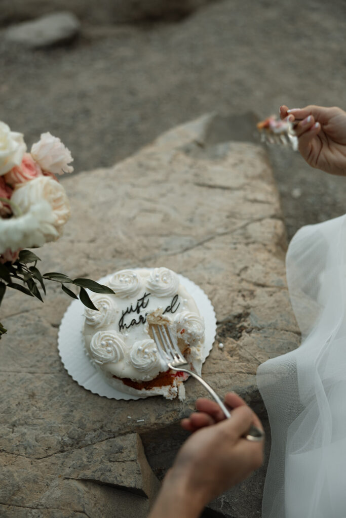 Couple embracing with expansive alpine landscape in the background | sun point elopement