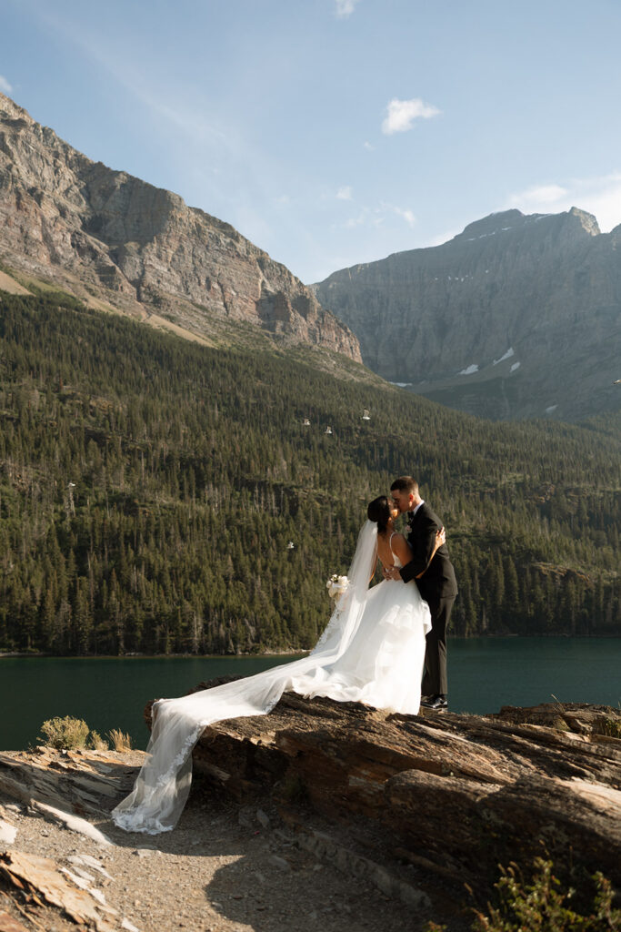 Couple embracing with expansive alpine landscape in the background | sun point elopement