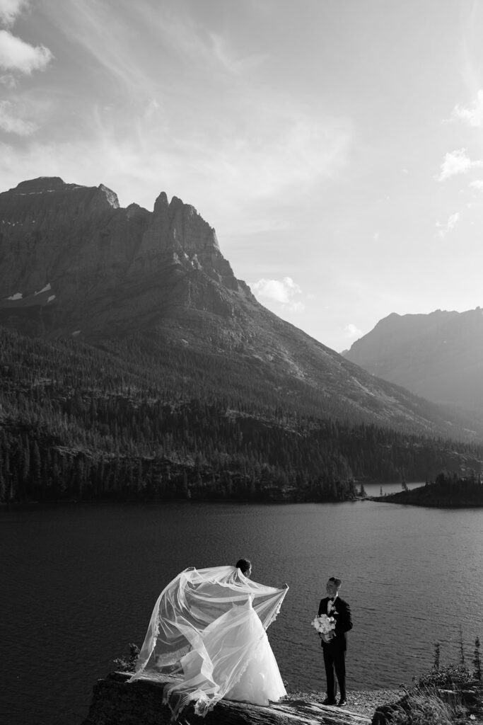 Couple embracing with expansive alpine landscape in the background | sun point elopement
