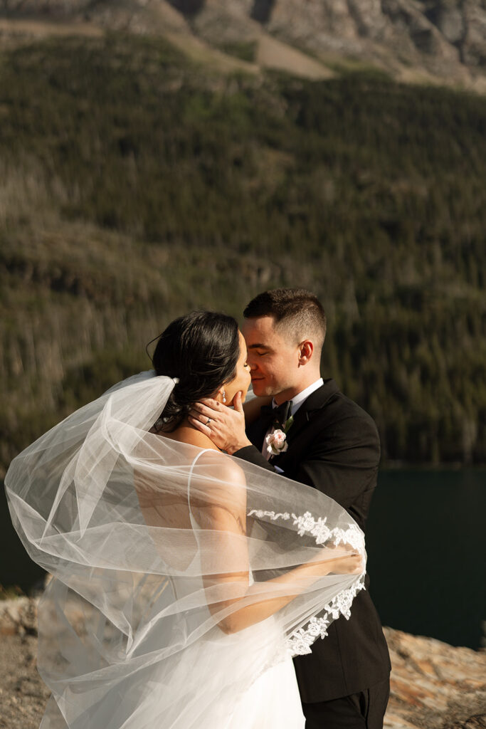 Couple embracing with expansive alpine landscape in the background | sun point elopement