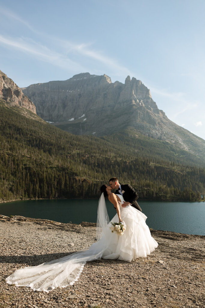 Couple embracing with expansive alpine landscape in the background | sun point elopement