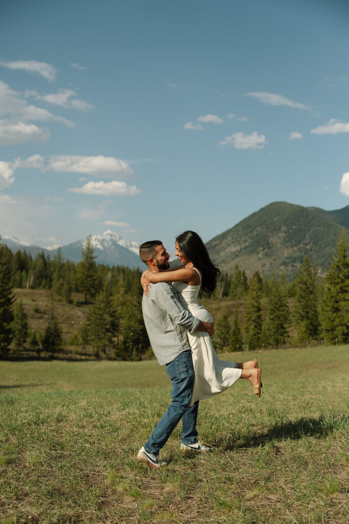 Romantic moment between couple surrounded by scenic views in Glacier National Park engagement session
