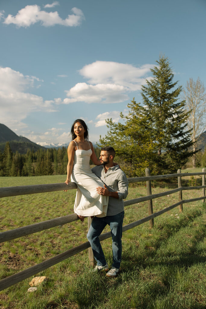 Romantic moment between couple surrounded by scenic views in Glacier National Park engagement session
