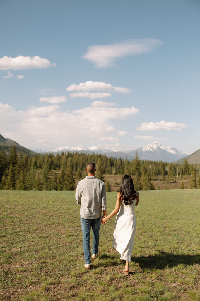 Romantic moment between couple surrounded by scenic views in Glacier National Park engagement session
