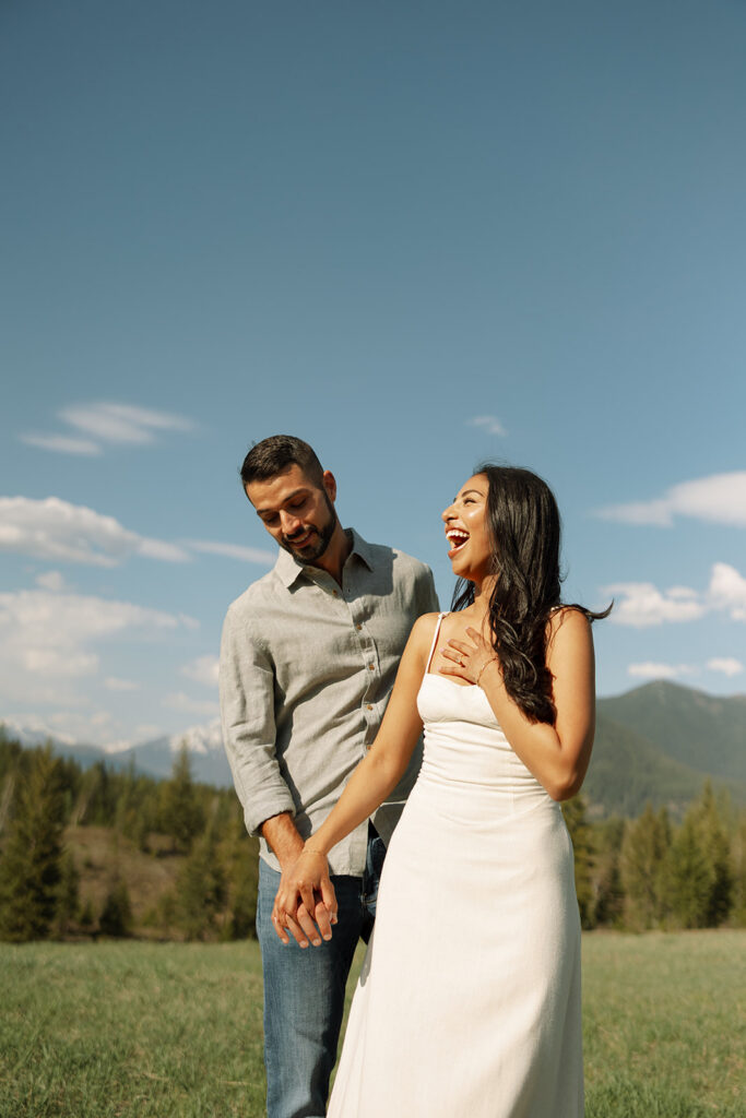 Romantic moment between couple surrounded by scenic views in Glacier National Park engagement session
