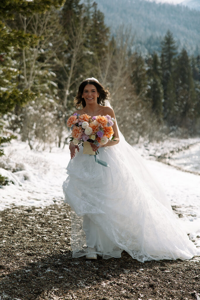 Emotional ceremony during an elopement at Lake McDonald with guests gathered in a quiet snowy landscape
