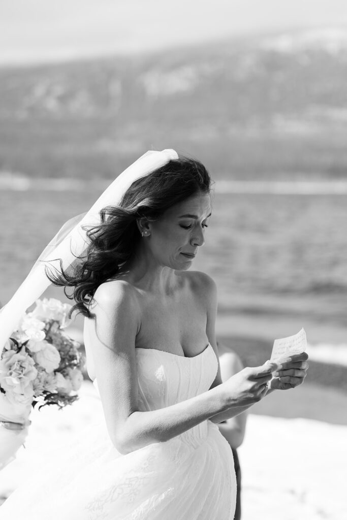 Emotional ceremony during an elopement at Lake McDonald with guests gathered in a quiet snowy landscape
