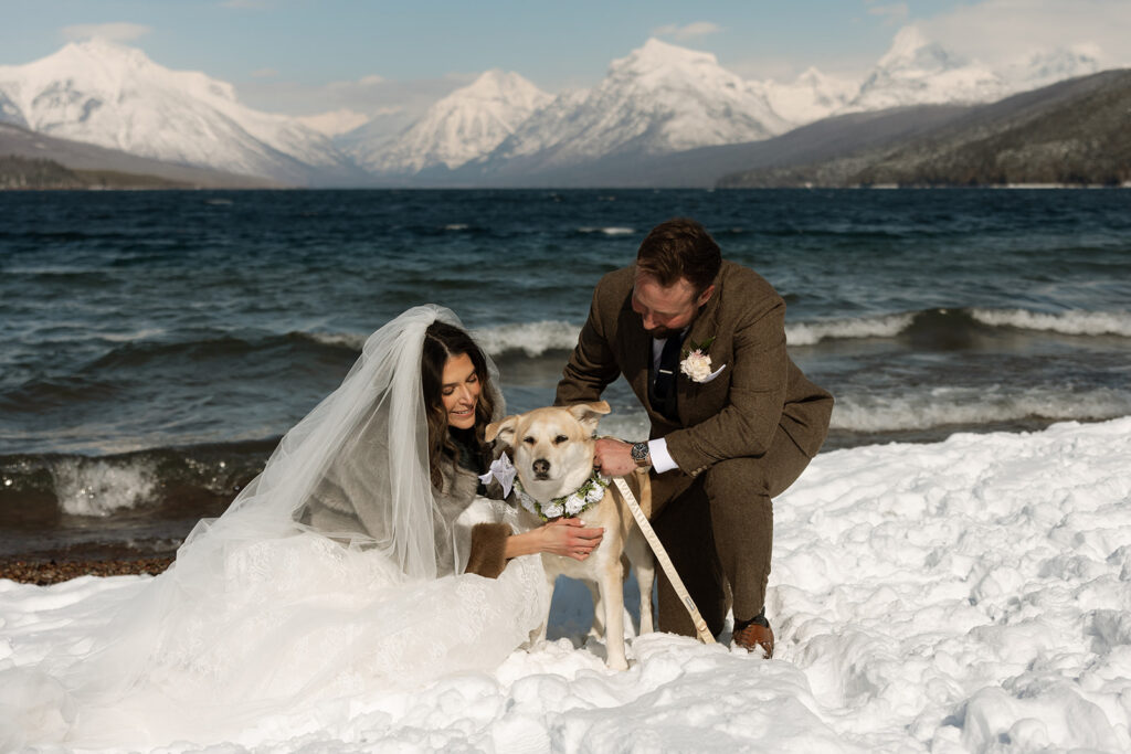Emotional ceremony during an elopement at Lake McDonald with guests gathered in a quiet snowy landscape
