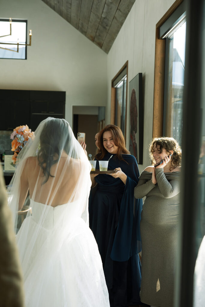 Intimate wedding moment inside a cozy cabin with mountain views and soft natural light
