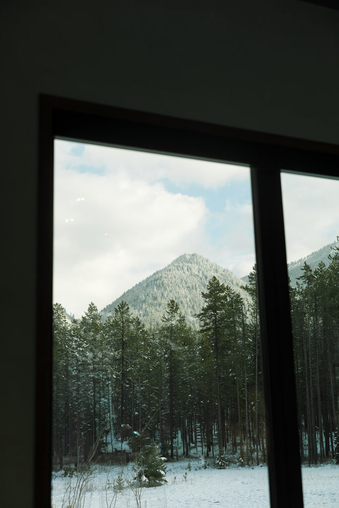 Intimate wedding moment inside a cozy cabin with mountain views and soft natural light