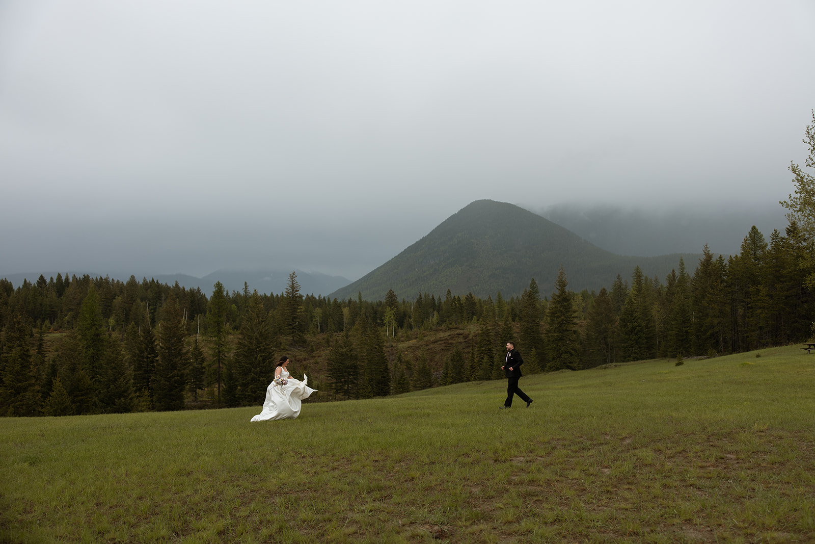 Couple eloping in Glacier National Park with mountain views in the background