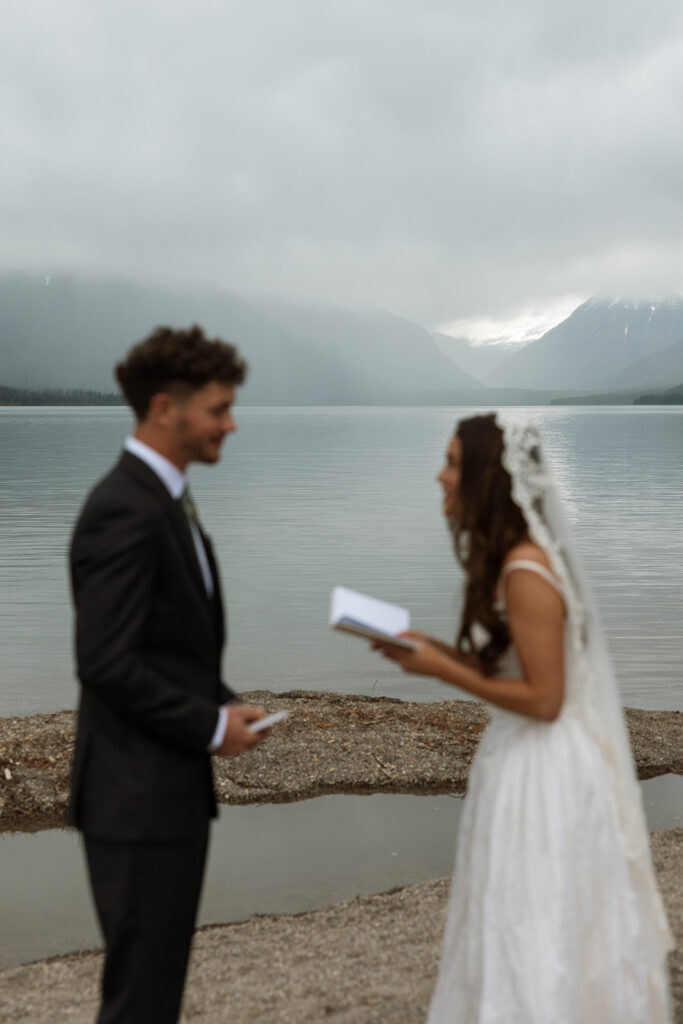 Scenic elopement portraits at 7 Mile Pullout overlooking Lake McDonald and the surrounding mountains.