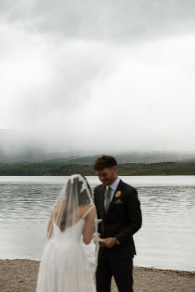 Couple embracing during a romantic Glacier National Park elopement with mountain views in the background.