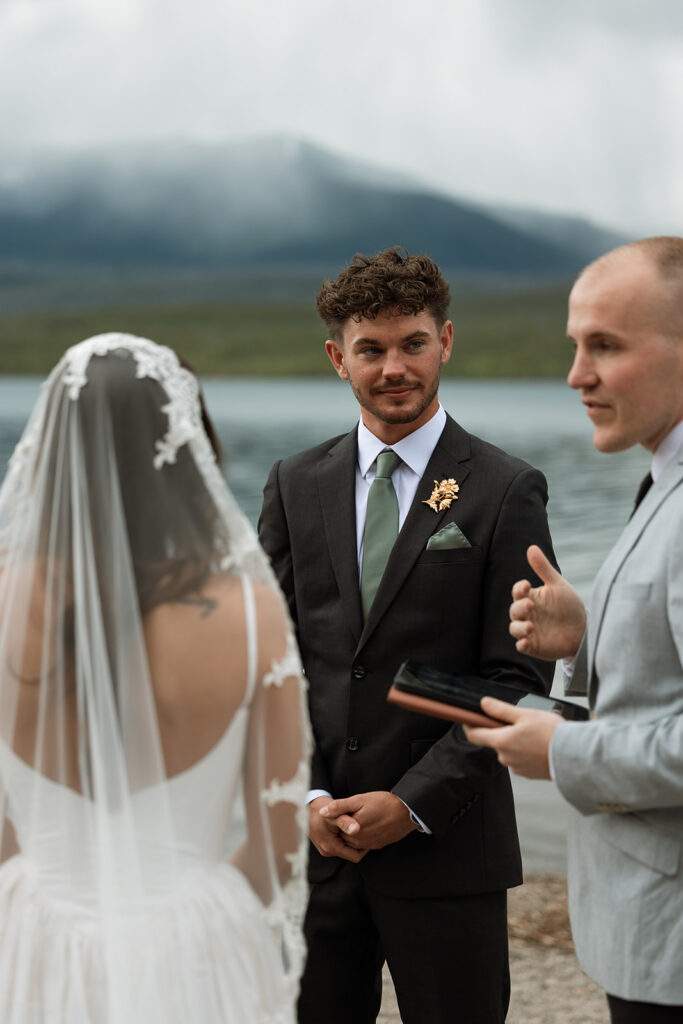 Newly married couple celebrating their Glacier National Park elopement in a beautiful natural landscape.