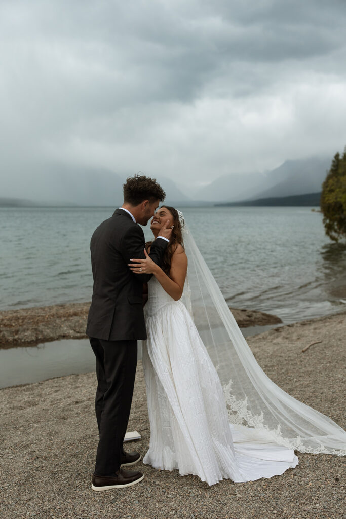 Newly married couple celebrating their Glacier National Park elopement in a beautiful natural landscape.