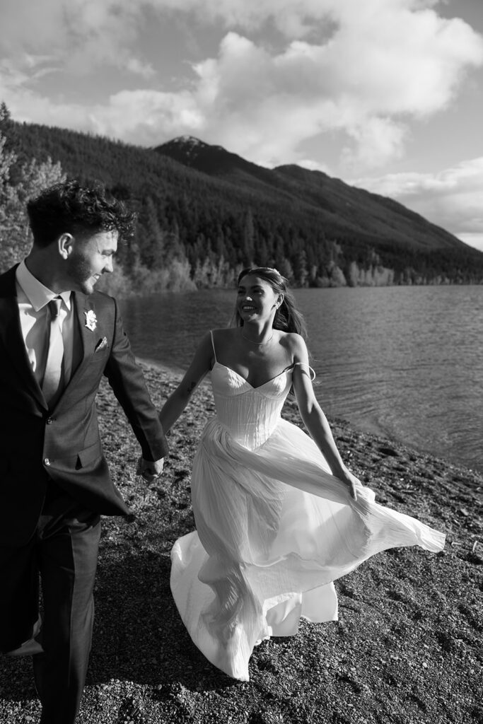 Scenic elopement portraits at 7 Mile Pullout overlooking Lake McDonald and the surrounding mountains.